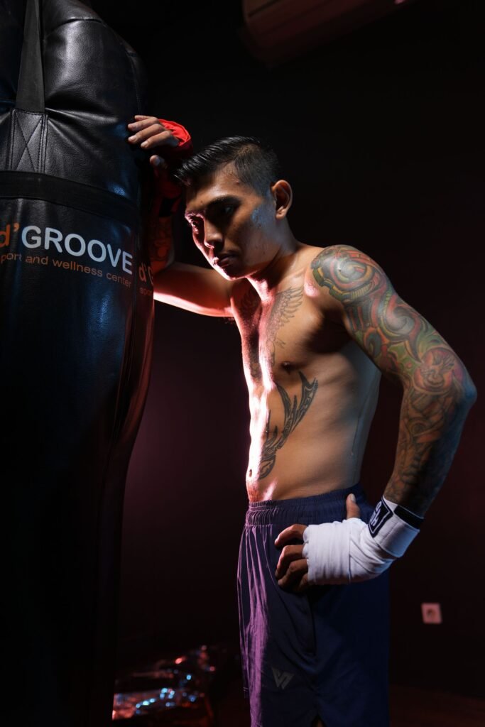 Focused boxer in low-key gym lighting for boxing mindset and discipline article